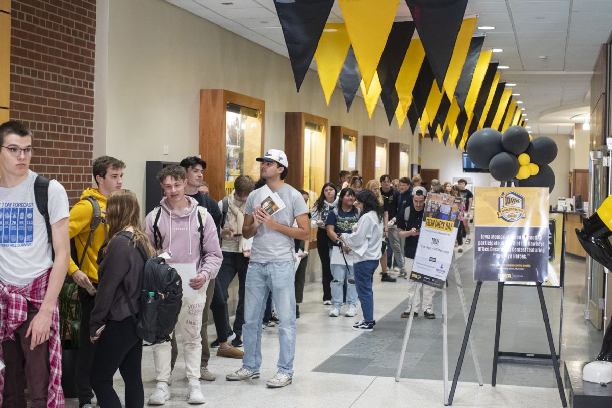 Early voters line up to cast their ballots during early voting at the Iowa Memorial Union on Oct. 23. Hundreds of students showed up at the IMU for the final day for early voting at the satellite early voting site.