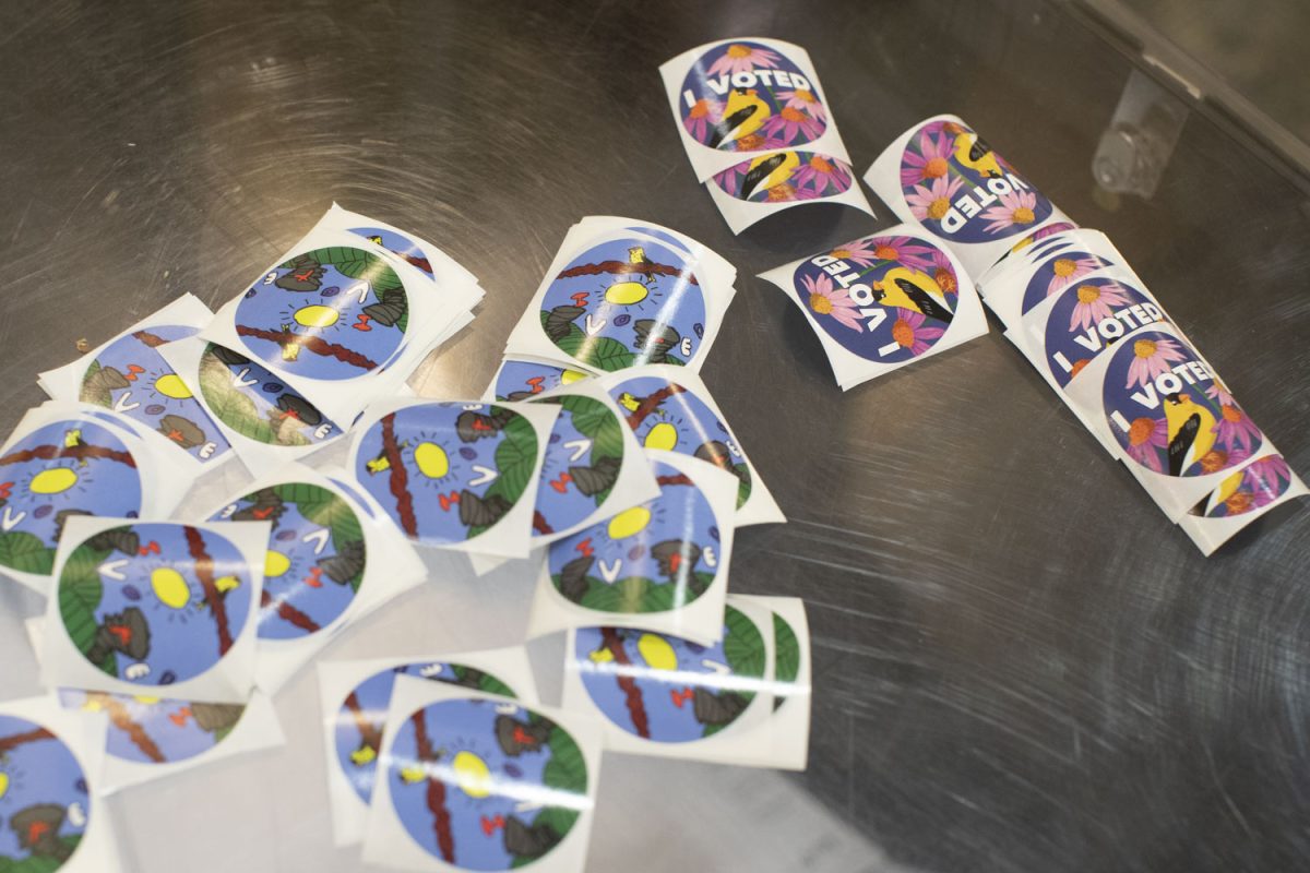 Stickers are laid out on a table for voters during early voting at the Iowa Memorial Union on Wednesday, Oct. 23, 2024. 