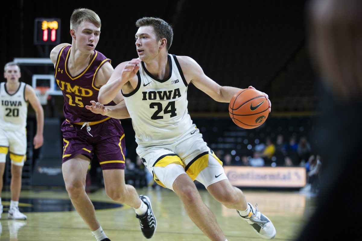 Iowa forward Pryce Sandfort (24) dribbles the ball during a men’s basketball game between Iowa and Minnesota-Duluth at Carver-Hawkeye Arena in Iowa City on Friday, Oct. 25, 2024. The Hawkeyes defeated the Bulldogs, 102-81.