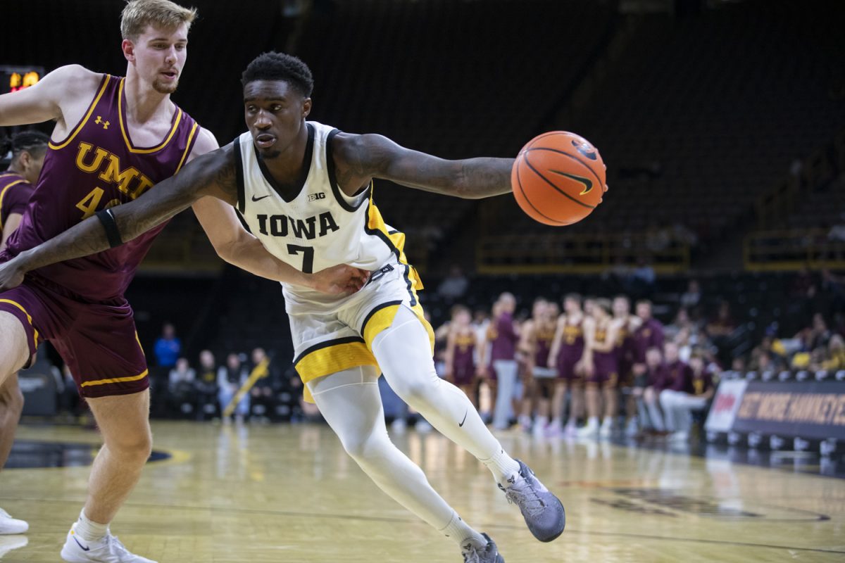 Iowa forward Seymour Traore (7) dribbles the ball during a men’s basketball game between Iowa and Minnesota-Duluth at Carver-Hawkeye Arena in Iowa City on Friday, Oct. 25, 2024. The Hawkeyes defeated the Bulldogs, 102-81.