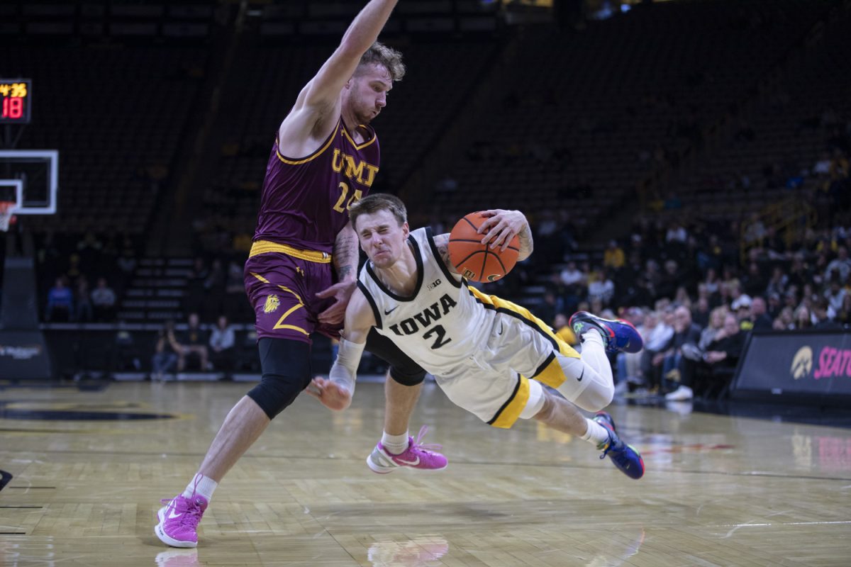 Iowa guard Brock Harding (2) is fouled by Minnesota-Duluth forward Charlie Katona during a men’s basketball game between Iowa and Minnesota-Duluth at Carver-Hawkeye Arena in Iowa City on Friday, Oct. 25, 2024. The Hawkeyes defeated the Bulldogs, 102-81.