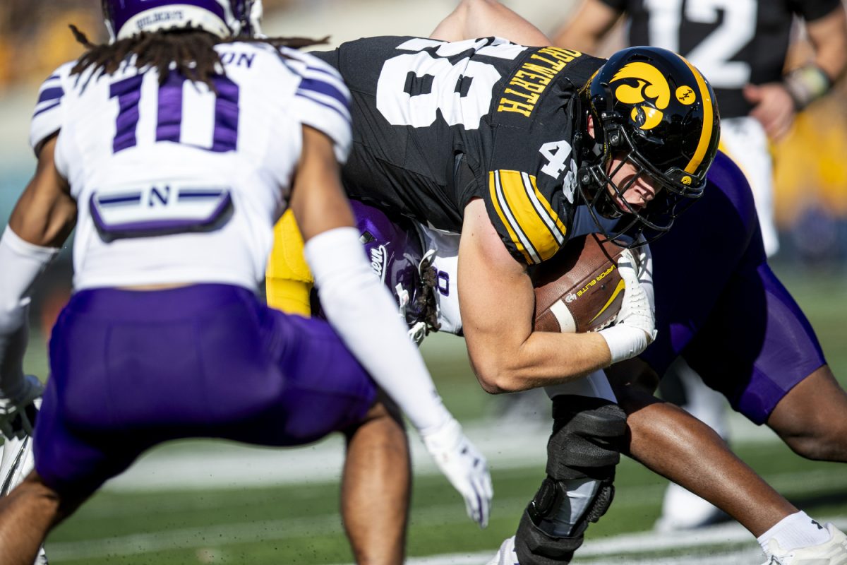 Iowa tight end Zach Ortwerth carries the ball during a football game between Iowa and Northwestern at Kinnick Stadium on Saturday, Oct. 26, 2024. Following the first half the Hawkeyes lead the Wildcats, 12-7. (Cody Blissett/The Daily Iowan)