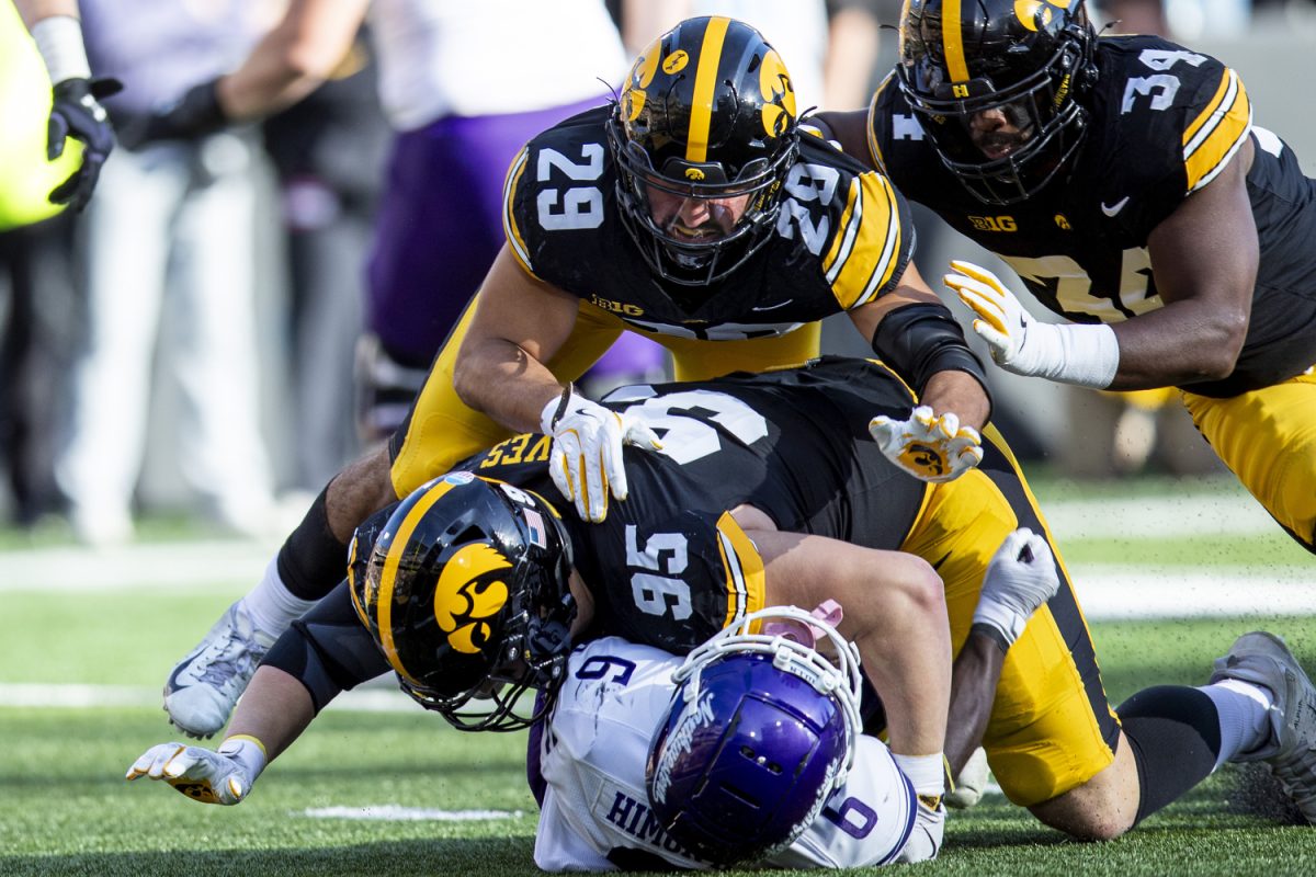Iowa defensive lineman Aaron Graves takes Northwestern running back Joseph Himon II during a football game between Iowa and Northwestern at Kinnick Stadium on Saturday, Oct. 26, 2024. Following the first half the Hawkeyes lead the Wildcats, 12-7. 
