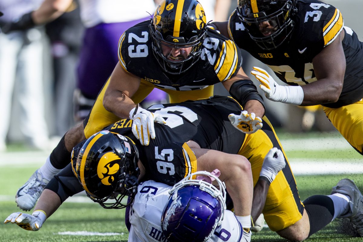 Iowa defensive lineman Aaron Graves tackles Northwestern running back Joseph Himon II during a football game between Iowa and Northwestern at Kinnick Stadium on Saturday, Oct. 26, 2024. The Hawkeyes defeated the Wildcats, 40-14.