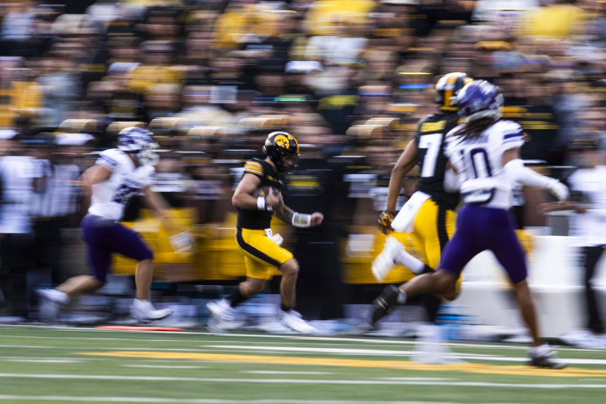 Iowa quarterback Brendan Sullivan runs the ball during a football game between Iowa and Northwestern at Kinnick Stadium on Saturday, Oct. 26, 2024. The Hawkeyes defeated the Wildcats 40-14.