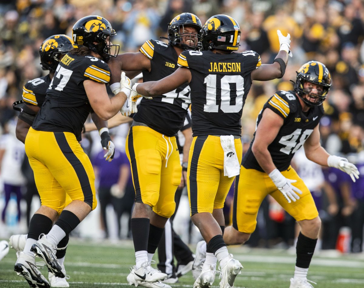 Iowa players celebrate Iowa defensive lineman Kenneth Merriweather during a fooball game between Iowa and Northwestern at Kinnick Stadium on Saturday, Oct. 26, 2024. The Hawkeyes defeated the Wildcats 40-14.