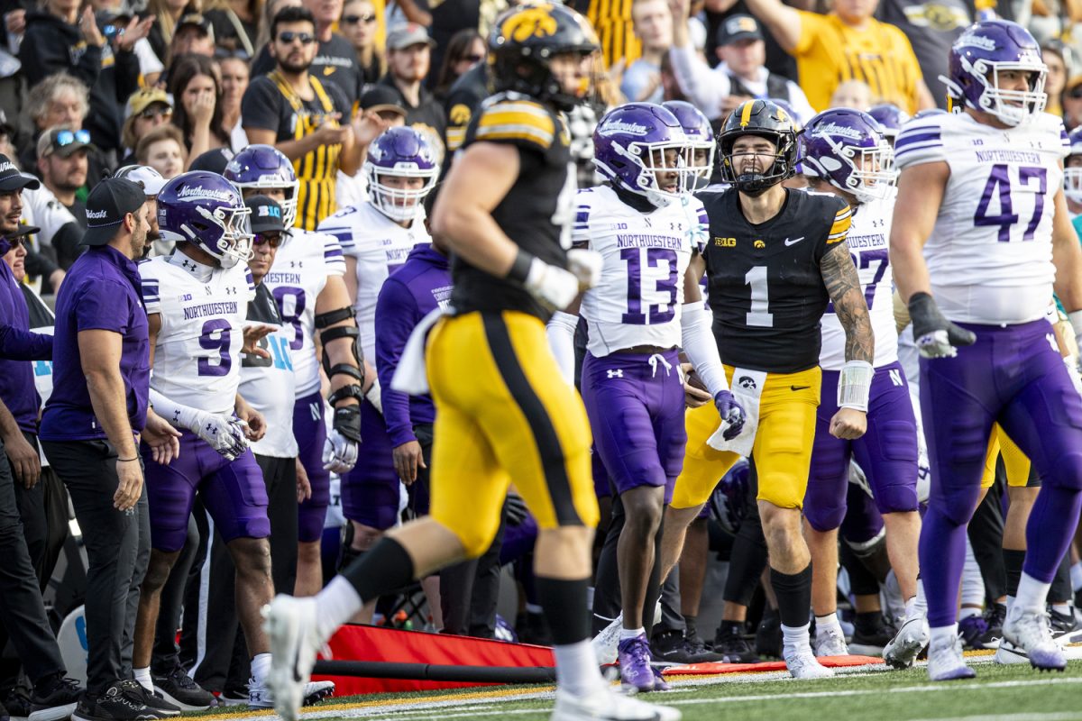 Iowa quarterback Brendan Sullivan celebrates on the sideline after running for a first down during a football game between Iowa and Northwestern at Kinnick Stadium on Saturday, Oct. 26, 2024. The Hawkeyes defeated the Wildcats, 40-14.