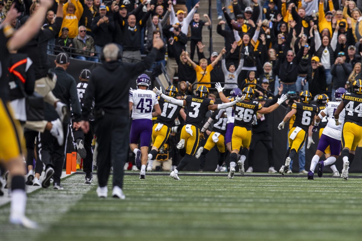 Players and fans react to a touchdown by Iowa wide receiver Kaden Wetjen during a football game between Iowa and Northwestern at Kinnick Stadium on Saturday, Oct. 26, 2024. The Hawkeyes defeated the Wildcats 40-14.