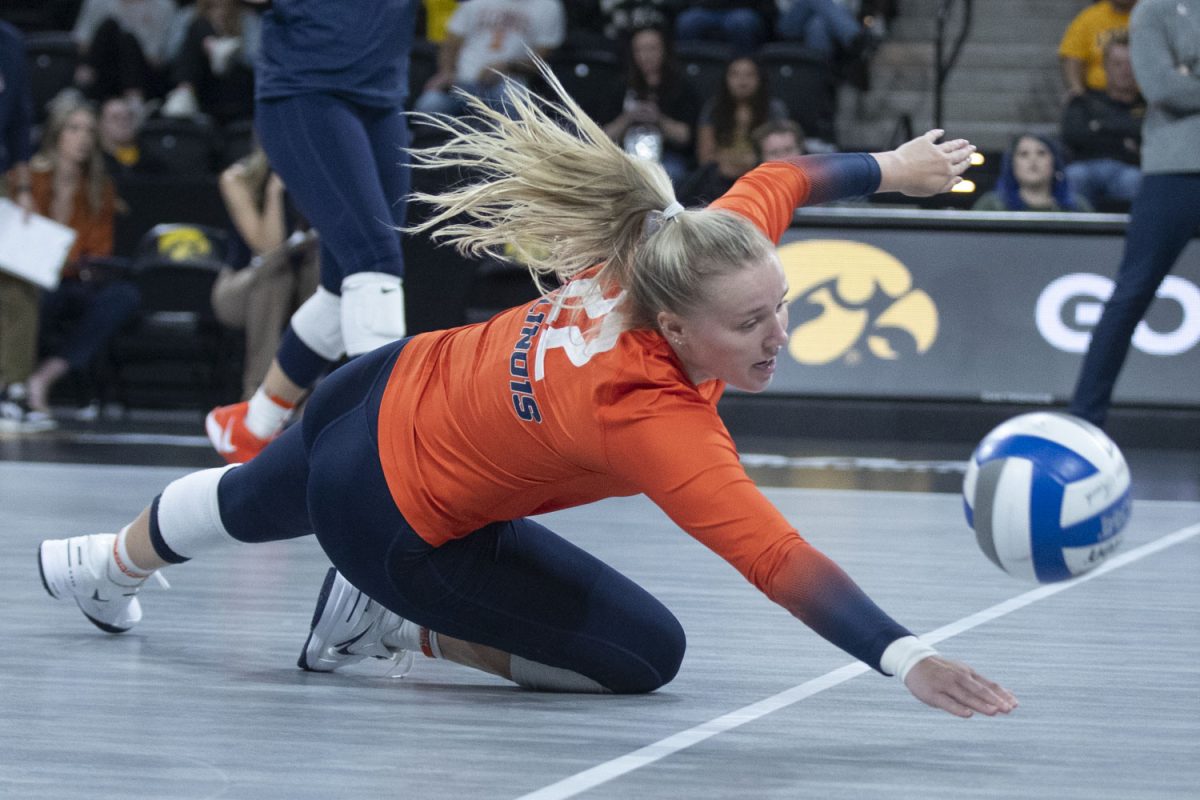 Brooke Mosher attempts to pancake save the ball during an Iowa Women’s Volleyball match at Xtreme Arena in Coralville on Sunday, Oct. 27, 2024. The Fighting Illini defeated the Hawkeyes 3-1, 25-21, 25-21, 25-27, and 25-13.