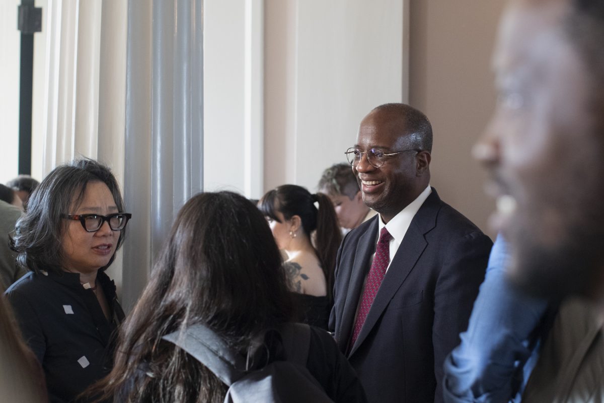 The Truman Capote Award for Literary Criticism recipient, Gene Andrew Jarrett, speaks with peers during the Truman Capote Award Ceremony and Reception in the Senate Chambers at The Old Capitol on Oct. 2. Jarrett won the award for his biography of Paul Laurence Dunbar; the $30,000 annual award is the largest cash prize for English-language literary criticism.