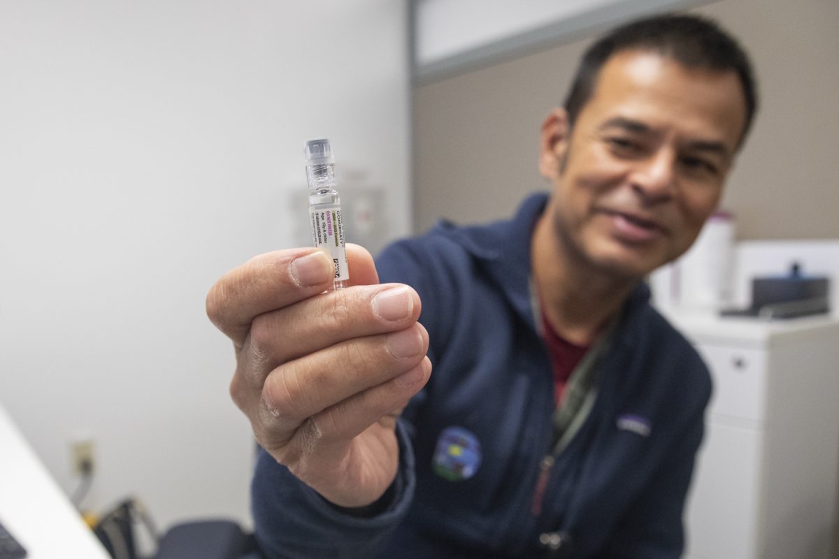 Nurse Dom Mascardo holds up a COVID shot in the Iowa Memorial Union QuickCare on Wednesday, Oct. 30, 2024. Less students are receiving the booster shot this winter than in previous years.