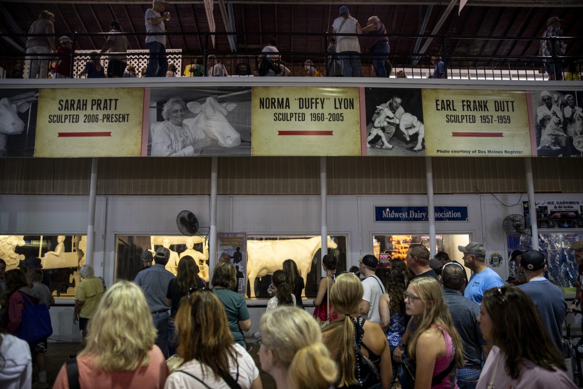 Fairgoers pass by the butter cow at the Iowa State Fair at the Iowa State Fairgrounds in
Des Moines on Aug. 13. The butter cow is set to be displayed at the Smithsonian Museum of
American Art in August of 2025.