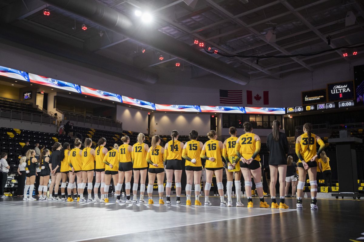 The Iowa women’s volleyball team stands for the national anthem during a volleyball game between No. 25 Washington and Iowa at Xtream Arena in Coralville on Saturday, Oct. 5, 2024. The Huskies defeated the Hawkeyes, 3-0.