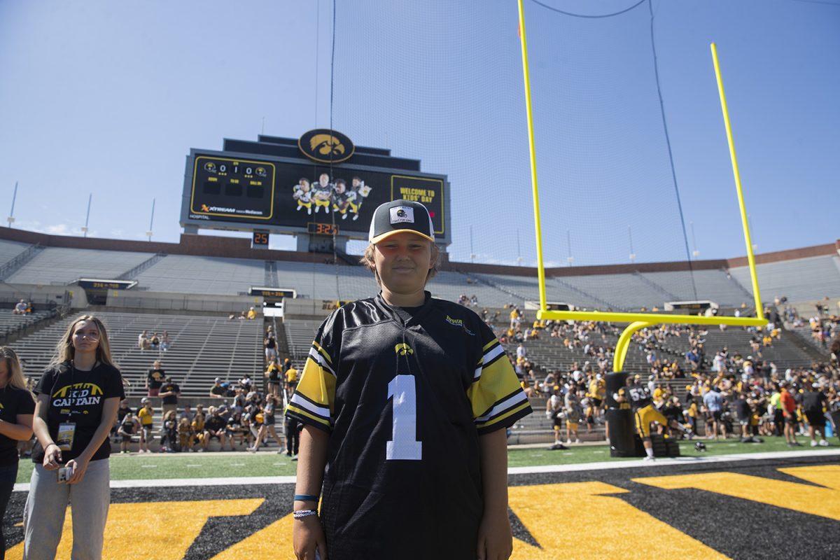 Iowa kid captain Hudson Ferris poses for a portrait during kid's day at Kinnick on Duke Slater field in Iowa City on Aug. 11, 2024. 