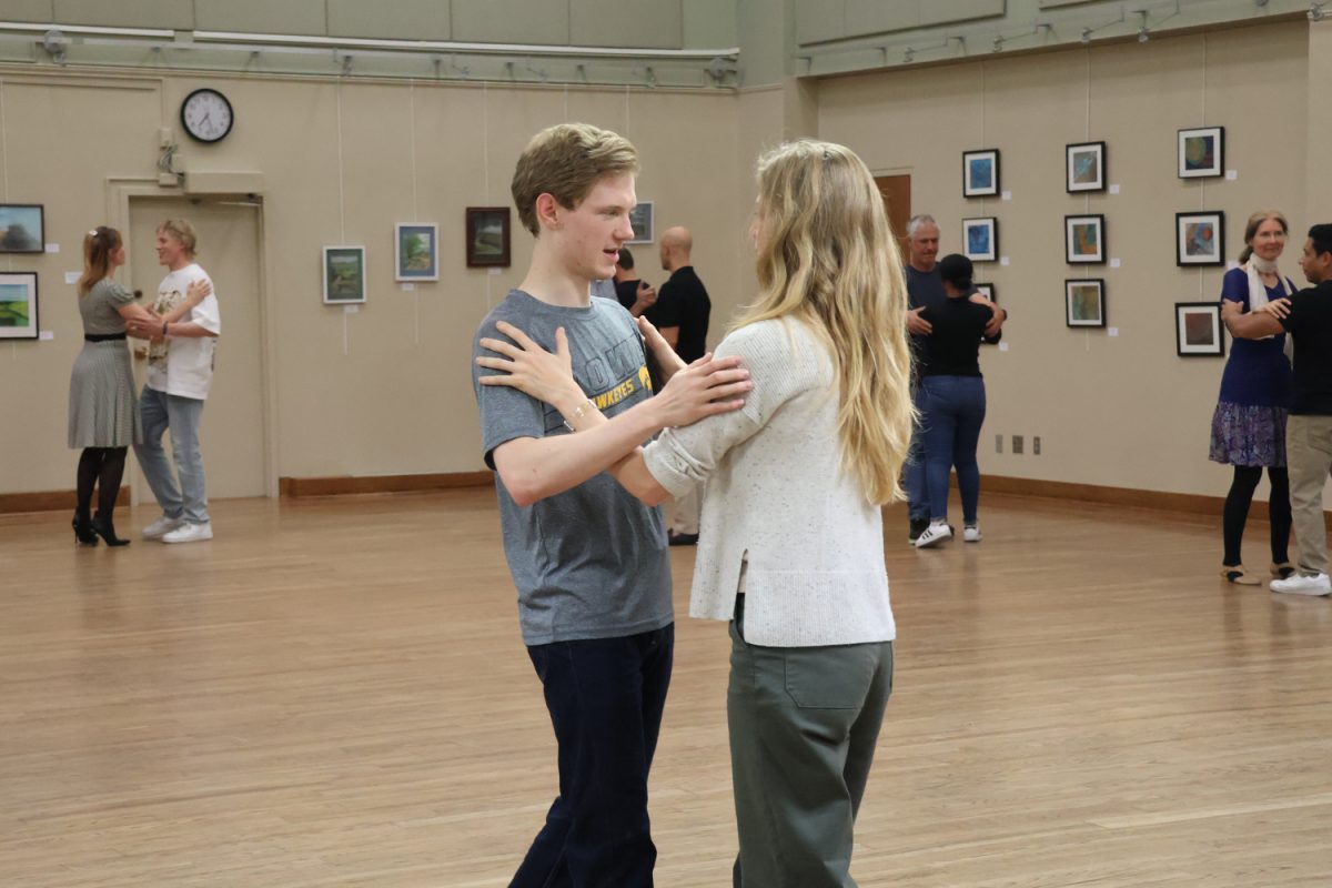 Two attendees tango during a social dance class at the Iowa City Senior Center on Friday, Oct. 18, 2024. The tango class was led by Irina Latkova from the Madison Tango Society and Abolins.