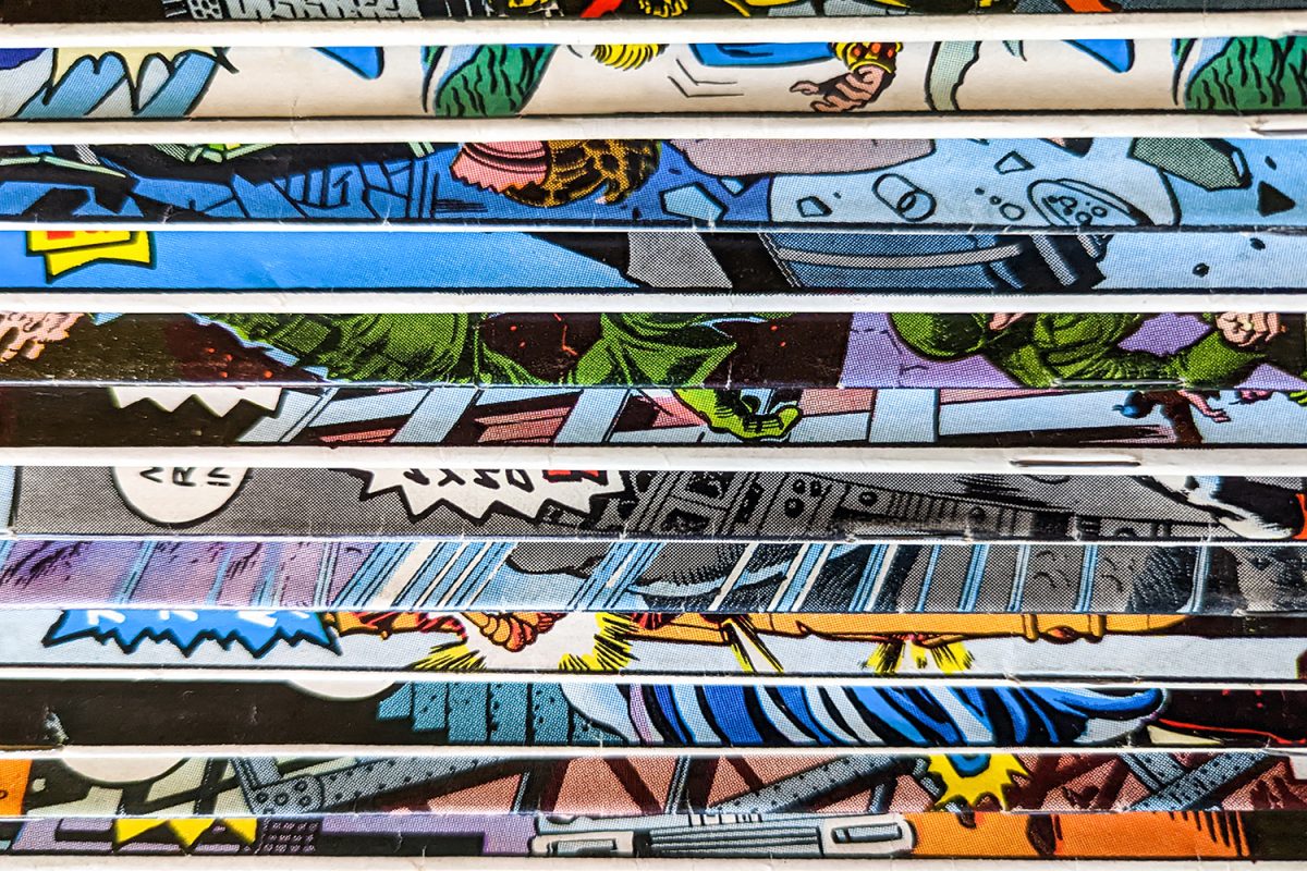 Vintage comic book collection stacked in a pile creates a background pattern of colorful lines and shapes on old paper