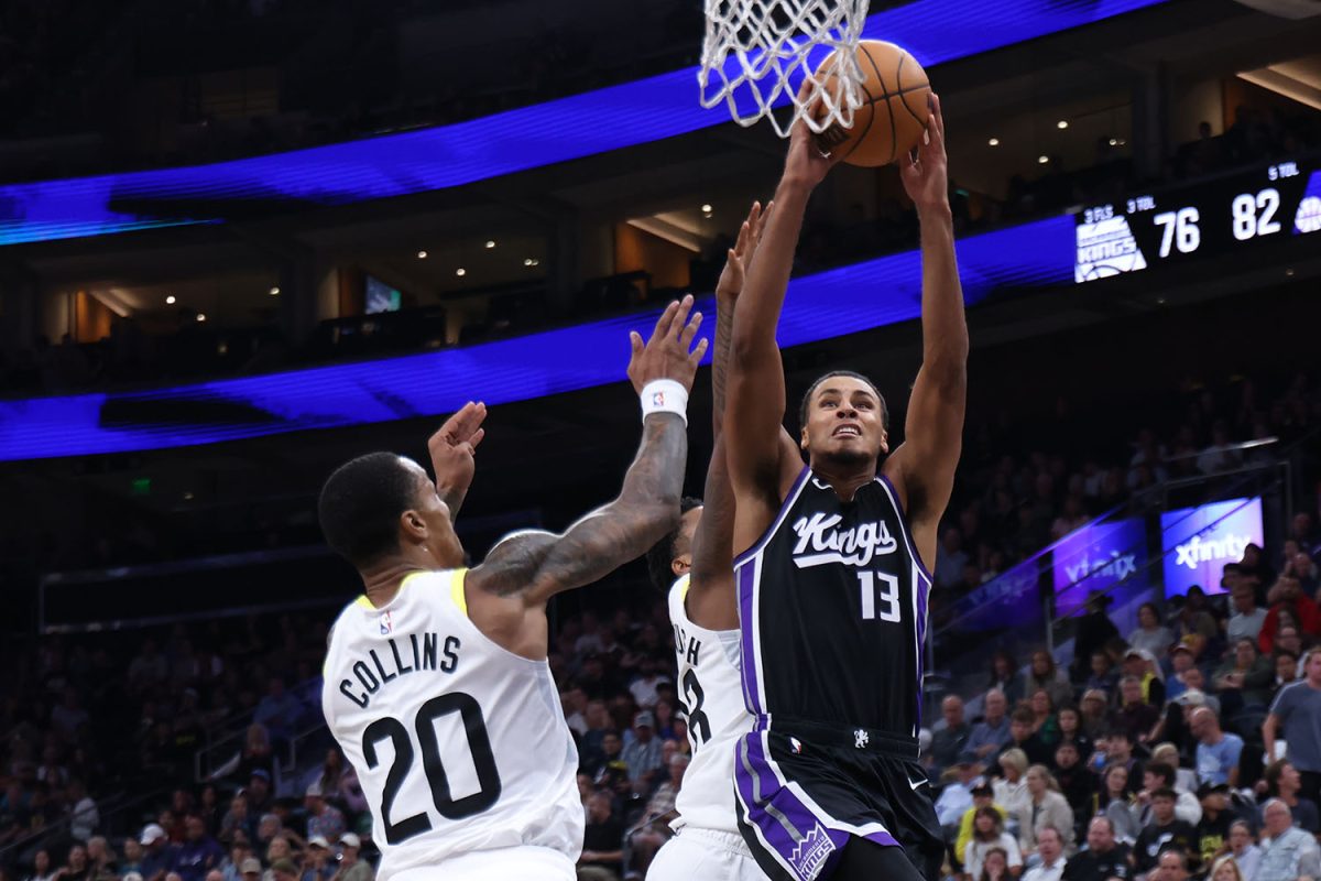 Oct 15, 2024; Salt Lake City, Utah, USA; Sacramento Kings forward Keegan Murray (13) goes to the basket against Utah Jazz forward John Collins (20) and forward Brice Sensabaugh (rear) during the third quarter at Delta Center. Mandatory Credit: Rob Gray-Imagn Images