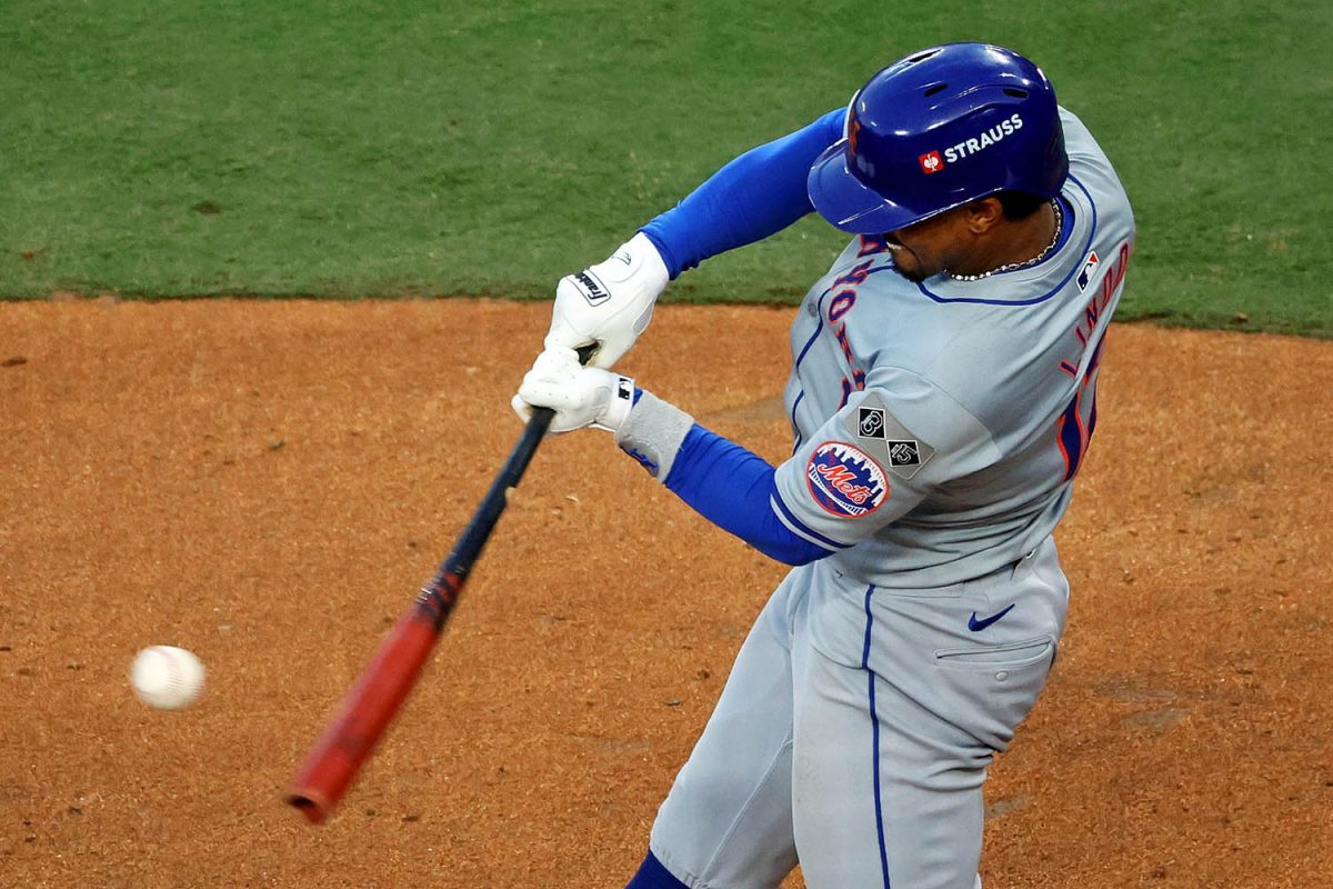 Oct 20, 2024; Los Angeles, California, USA; New York Mets shortstop Francisco Lindor (12) hits a single during the second inning against the Los Angeles Dodgers during game six of the NLCS for the 2024 MLB playoffs at Dodger Stadium. Mandatory Credit: Kiyoshi Mio-Imagn Images