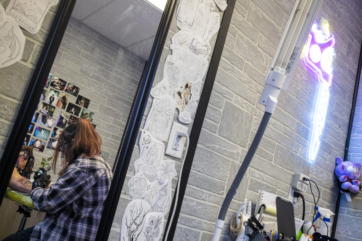 Nikkia Evans tattoos a client at Neon Dragon Tattoo Body Piercing in Cedar Rapids on Oct. 16, 2024. Evans has been an apprentice at Neon Dragon for a little over a year.