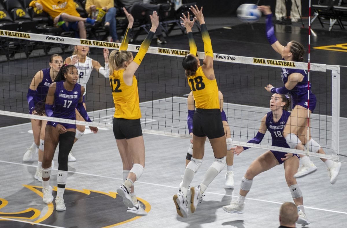 Iowa hitters Hannah Whittingstall and Malu Garcia block a hit during an Iowa Women’s Volleyball game against Northwestern on Sunday, Nov. 10, 2024. The Hawkeyes fell to the Wildcats, 3-1. 