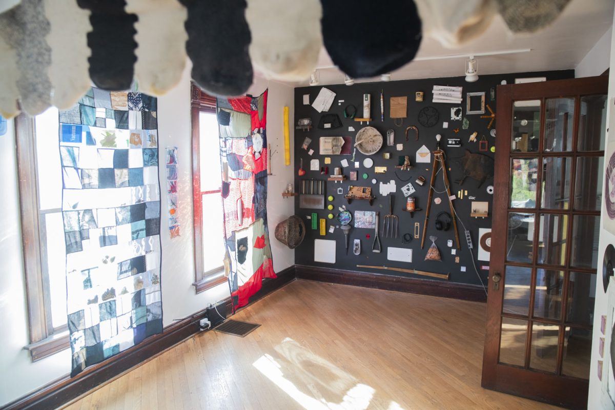 Art installations adorn the walls during open gallery hours of HOLD ON/LET GO inside Public Space One on North Gilbert Street on Saturday, Oct. 26, 2024. HOLD ON/LET GO is a community art project by University of Iowa MFA candidates Heather Steckler and Harper Folsom, incorporating unneeded objects donated from Iowa City residents.