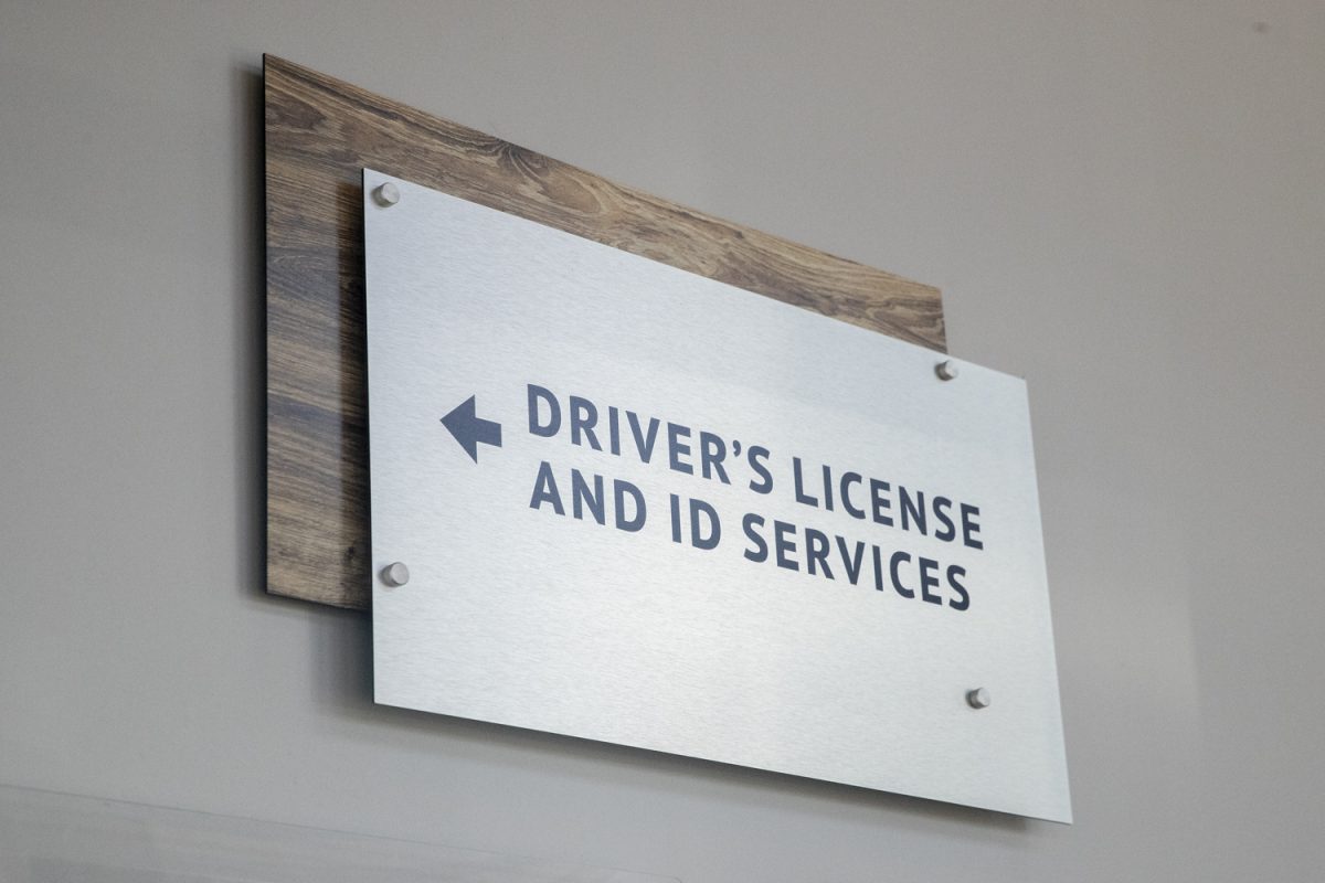 A sign pointing towards the the Iowa Department of Transportation building in Coralville is seen on Friday, Nov. 1, 2024. Iowa Mobile ID is now available to allow Iowans to store a digital copy of their ID on their phone.