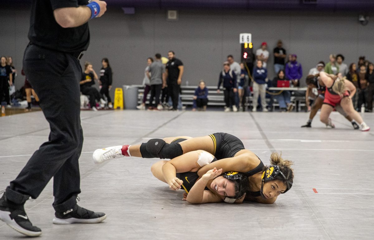 Iowa 160-pound Kennedy Blades and Iowa 160-pound Rose Cassioppi wrestle during the Luther Hill Open Titles at the Blake Field House in Indianola, Iowa, on Saturday, Nov. 2, 2024. Iowa ended the tournament with six champions and an overall record of 58-17. (Cody Blissett/The Daily Iowan)