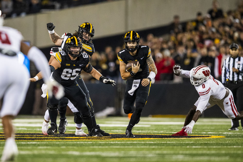 Iowa quarterback Brendan Sullivan runs the ball during a football game between Iowa and Wisconsin at Kinnick Stadium on Saturday, Nov. 2, 2024. The Hawkeyes defeated the Badgers 42-10.