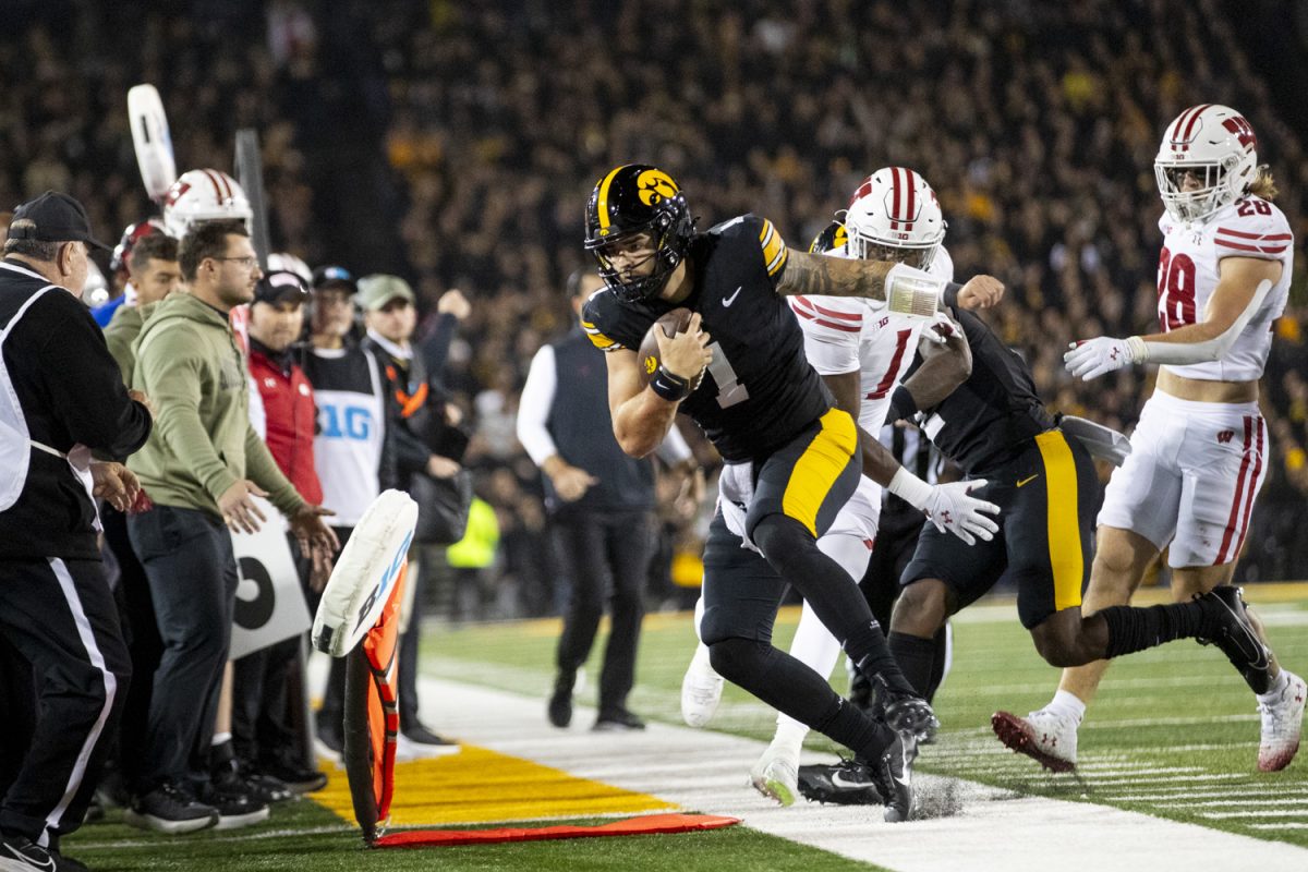 Iowa quarterback Brendan Sullivan runs out of bounds during a football game between Iowa and Wisconsin at Kinnick Stadium on Nov. 2. The Hawkeyes defeated the Badgers 42-10.