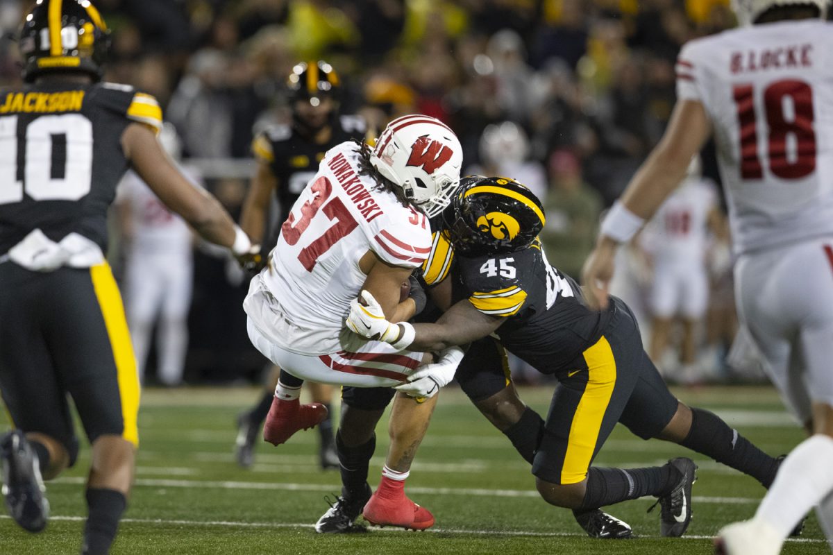 Iowa defensive lineman Deontae Craig tackles Badger tight end Riley Nowakowski during a football game  between Iowa and Wisconsin at Kinnick Stadium on Saturday, Nov. 2, 2024. The Hawkeyes defeated the Badgers 42-10. (Emma Calabro/The Daily Iowan)