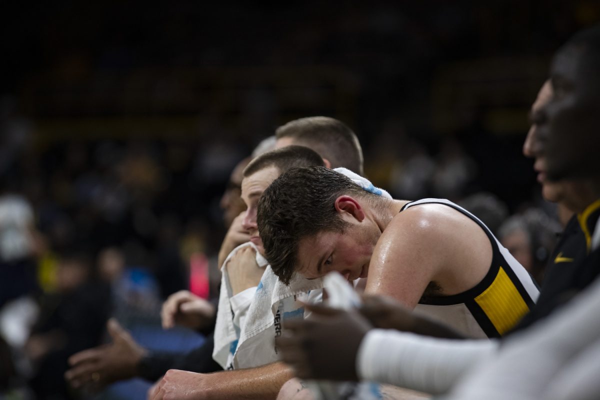 Iowa Forward Pryce Sandfort uses a towel while on the bench during an Iowa mens basketball game against Texas A&M Commerce at Carver-Hawkeye Arena in Iowa City on Monday, Nov 4, 2024. Sandfort put up 13 points on 33% three-point shooting. The Hawkeyes defeated the Lions, 89-67.