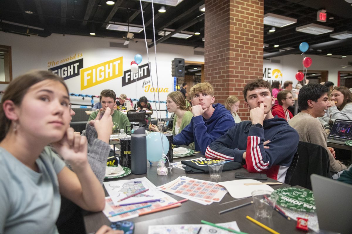 Attendees watch the televised news during an electoral map watch party in the Iowa Memorial Union on Election Day in Iowa City on Tuesday, Nov. 5, 2024. The watch party was organized by community organization Hawk The Vote, and had a turnout of over 300 students.