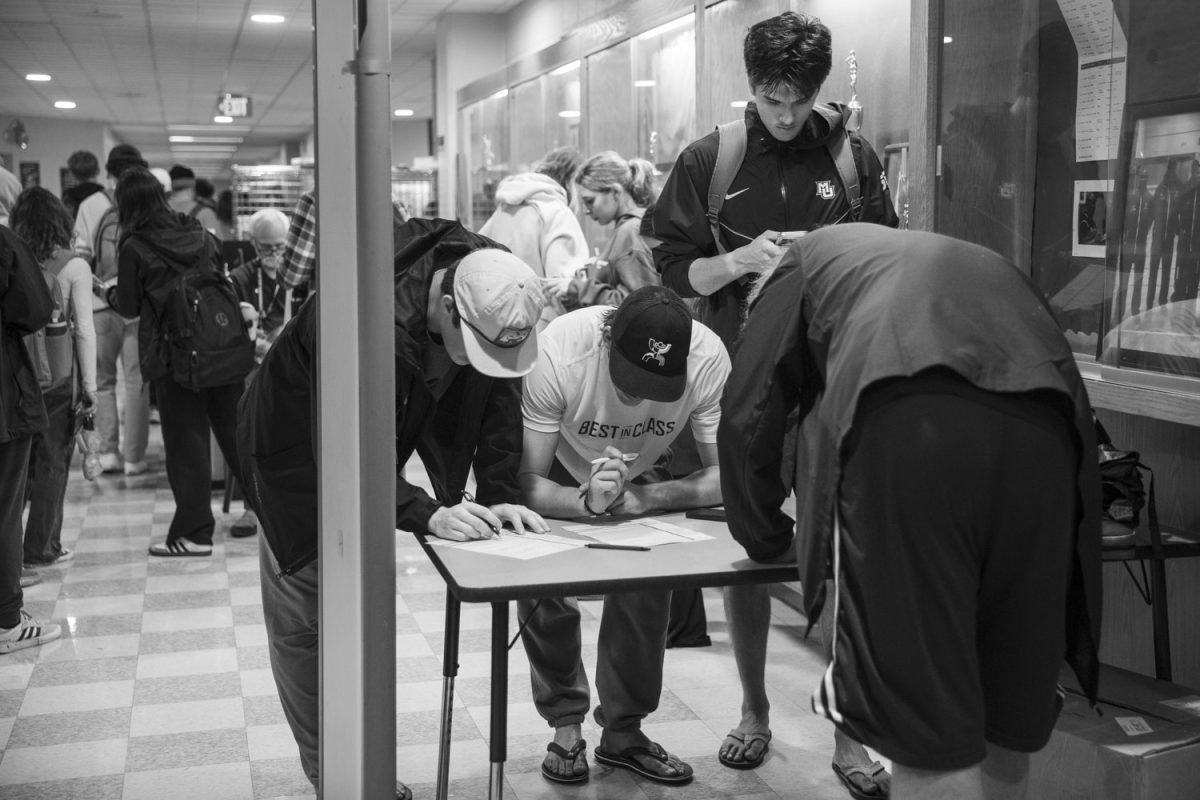 Students fill out voter information at Wisconsin Conservatory of Lifelong Learning on Election Day in Milwaukee, Wisconsin, on Tuesday, Nov. 5, 2024. an essential role in the outcome. The Conservatory of Lifelong Learning is one of five major polling stations that support the campus community. As of 2023, Milwaukee's population is 561,385.