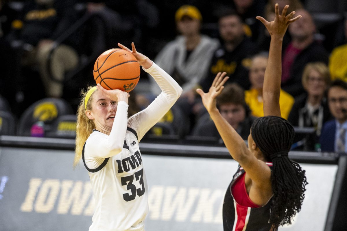 Iowa guard Lucy Olsen goes up for a 3-point shot during a women’s basketball game between Iowa and Northern Illinois at Carver-Hawkeye Arena in Iowa City on Wednesday, Nov. 6, 2024. Olsen had 19 points, seven assists, and four rebounds. The Hawkeyes defeated the Huskies 91-73.