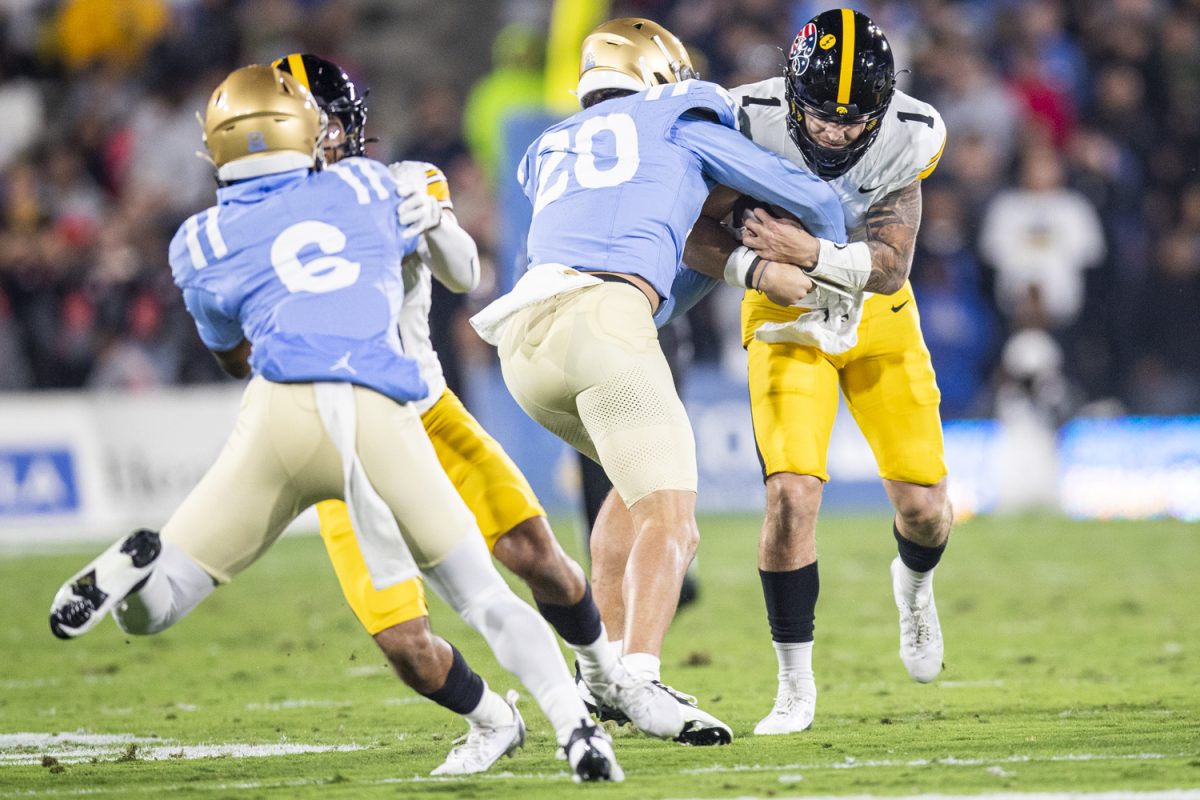 UCLA linebacker Kain Medrano tackles Iowa quarterback Brendan Sullivan forcing a fumble during a football game between Iowa and UCLA at the Rose Bowl Stadium in Pasadena, Calif. on Friday Nov. 8, 2024.