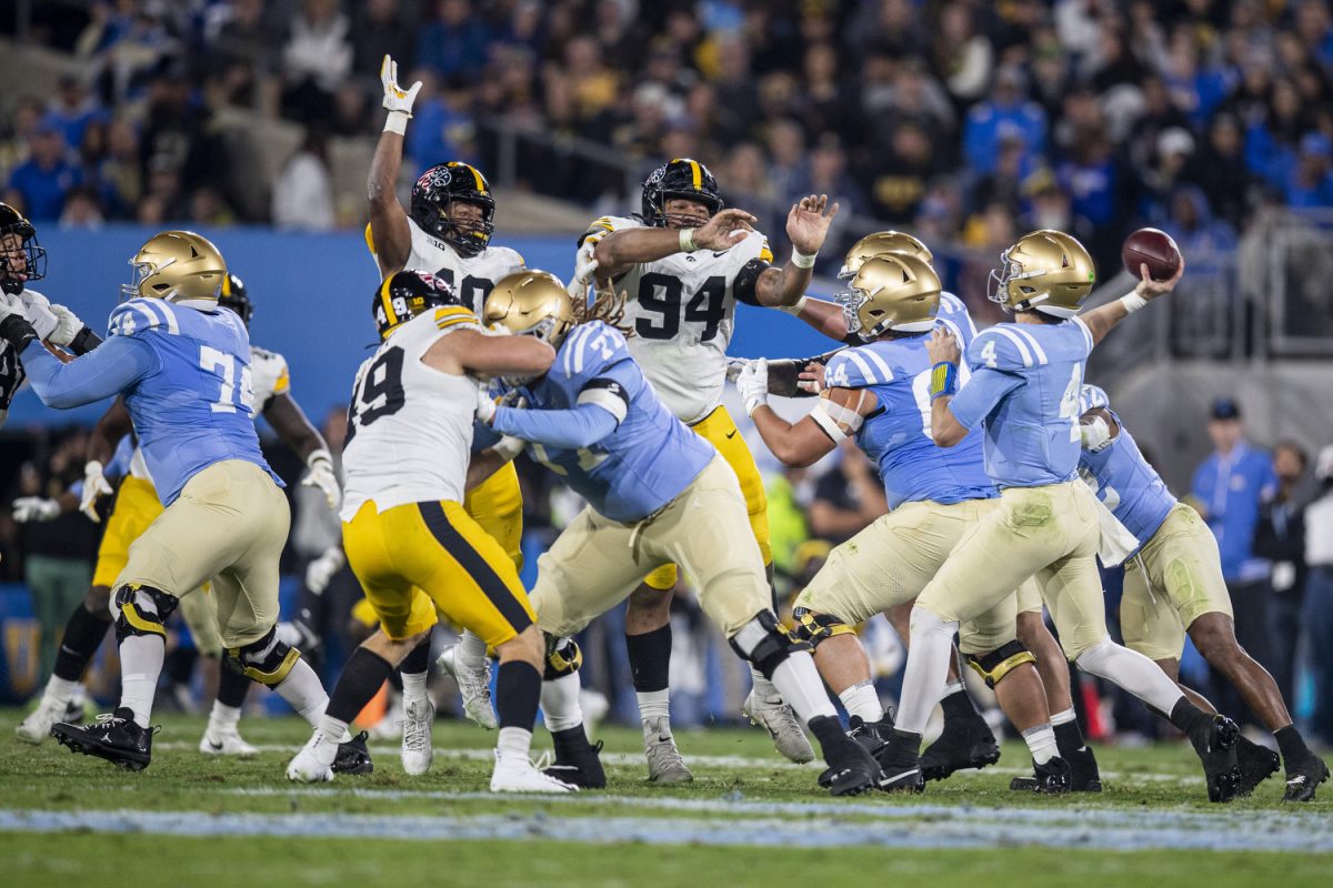 Iowa linebacker Nick Jackson and Iowa defensive lineman Yahya Woody try to block UCLA quarterback Ethan Garbers’ pass during a football game between Iowa and UCLA at the Rose Bowl Stadium in Pasadena, Calif. on Friday Nov. 8, 2024. The Bruins defeated the Hawkeyes 20-17.