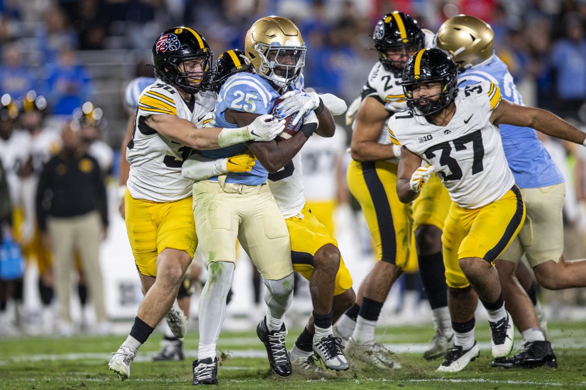 UCLA running back T.J. Harden tries to break tackles during a football game between Iowa and UCLA at the Rose Bowl Stadium in Pasadena, Calif. on Friday Nov. 8, 2024. The Bruins defeated the Hawkeyes 20-17.