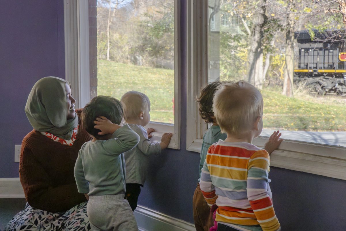 Students watch a train pass at the Good Shepherd Center for early childhood education on Tuesday, Nov. 12, 2024. The center participated in the Johnson County child care wage enhancement program, which increased wages by $2 per hour.