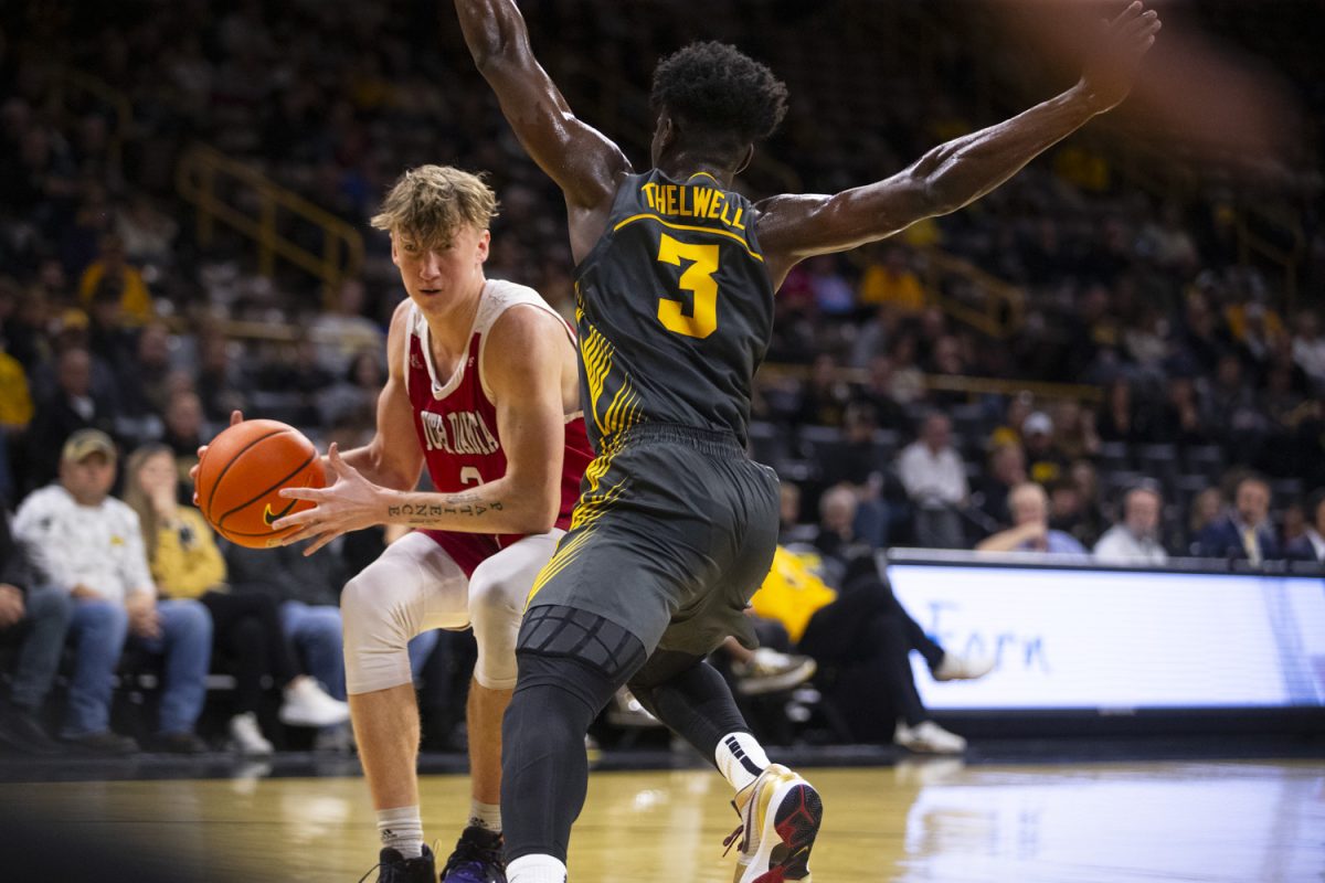 Iowa guard Drew Thelwell defends against a Coyote player during a men's basketball game between Iowa and South Dakota at Carver-Hawkeye Arena in Iowa City on Tuesday, Nov. 12, 2024. The Hawkeyes defeated the Coyotes 96-77.