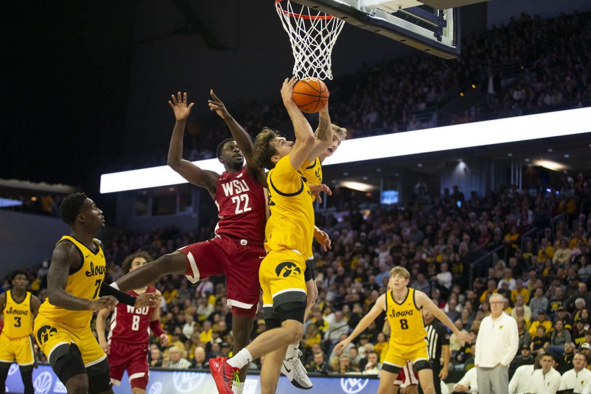 Owen Freeman goes up for a rebound during a men's basketball game between Iowa and Washington State at Vibrant Arena in Moline, Illinois, on Friday, Nov. 15, 2024.