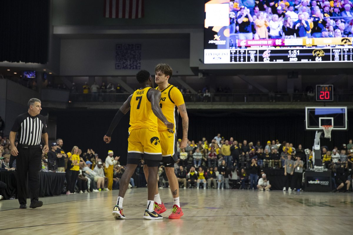 Seydou Traore and Owen Freeman chest bump during a men's basketball game between Iowa and Washington State at Vibrant Arena in Moline, Illinois, on Friday, Nov. 15, 2024. The Hawkeyes defeated the Cougars 76-66.