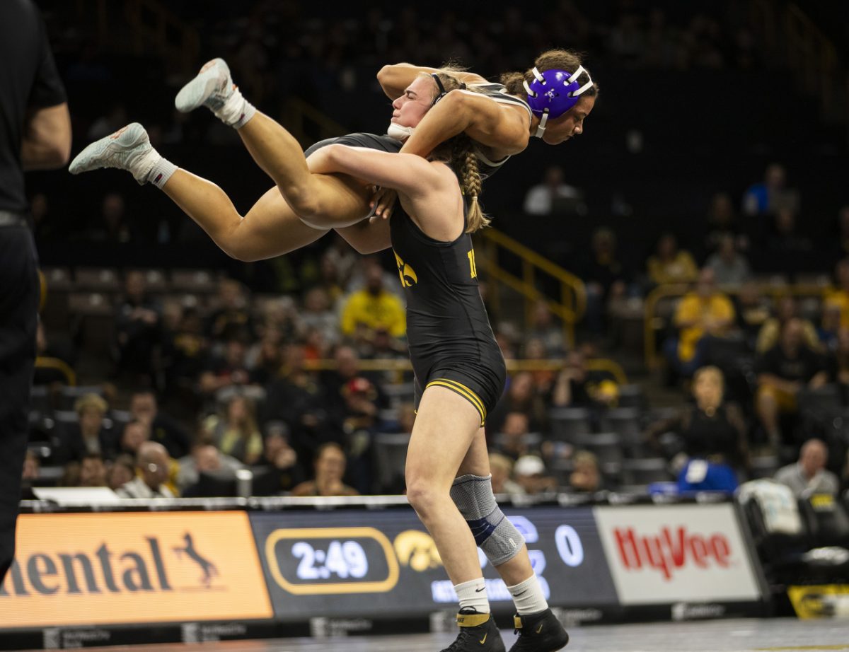 Iowa  No. 1 145-pound Reese Larramendy throws Cornell College Jasmine McCaskel during  the Trailblazer duals between No. 1 Iowa, No. 25 William Jewell College, and Cornell College at Carver-Hawkeye Arena in Iowa City on Saturday, Nov. 16, 2024. Iowa defeated Cornell, 47-0 and William Jewell, 43-3.