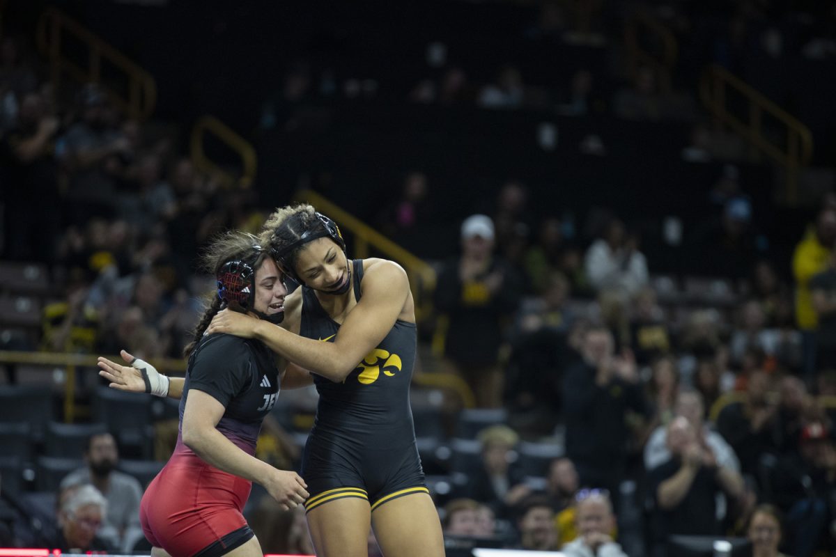 Iowa No. 2 160-pound Kennedy Blades pats William Jewell College 160-pound Nylease Yzagere on the back after  the Trailblazer duals between No. 1 Iowa, No. 25 William Jewell College, and Cornell College at Carver-Hawkeye Arena in Iowa City on Saturday, Nov. 16, 2024. Iowa defeated Cornell, 47-0 and William Jewell, 43-3.