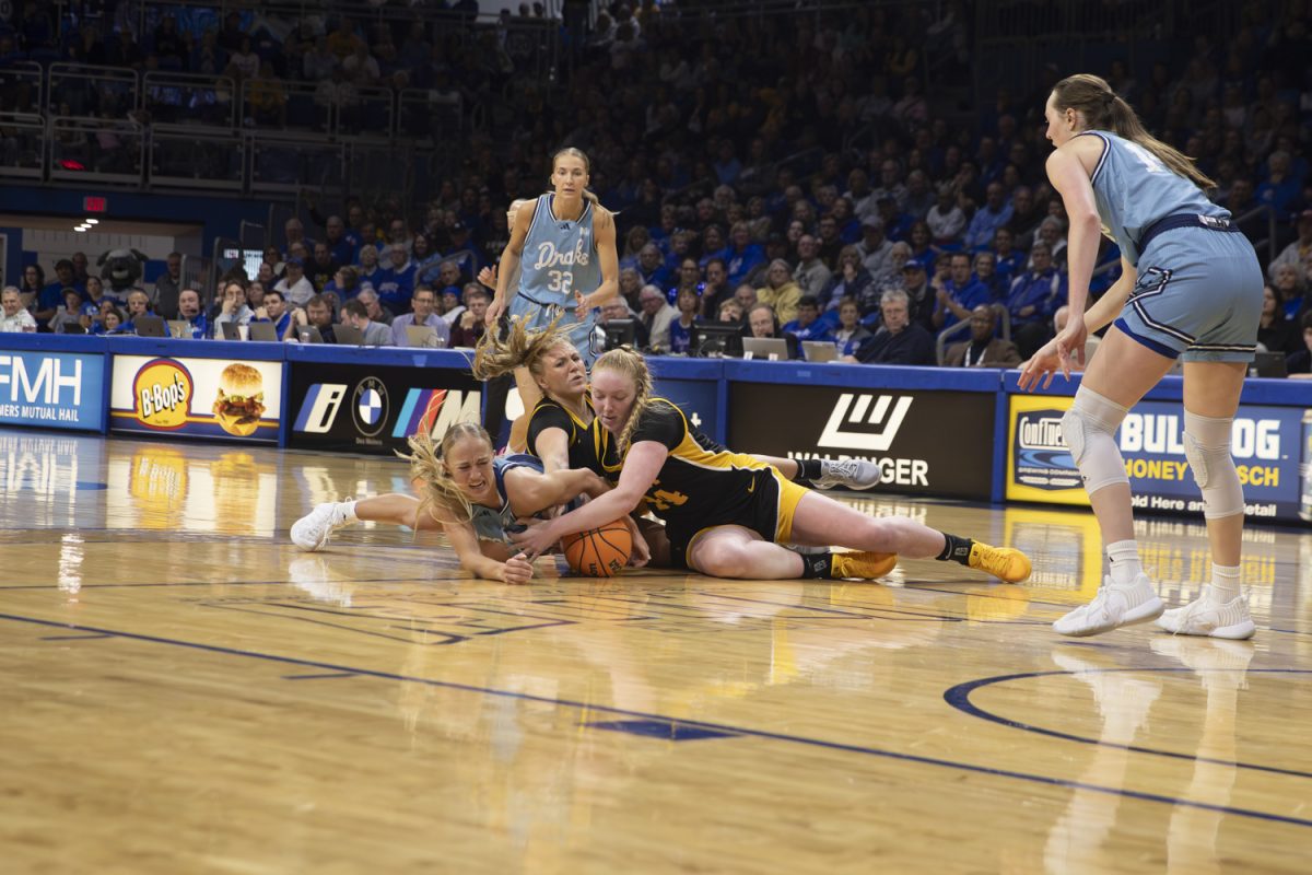 Addison O’Grady, Katie Dinnebier, and Sydney Affolter fight for a jump ball during an Iowa women’s basketball game against Drake at the Knapp Center on Nov. 17 in Des Moines. The Hawkeyes defeated the Bulldogs, 86-73, with standout performances on both teams.