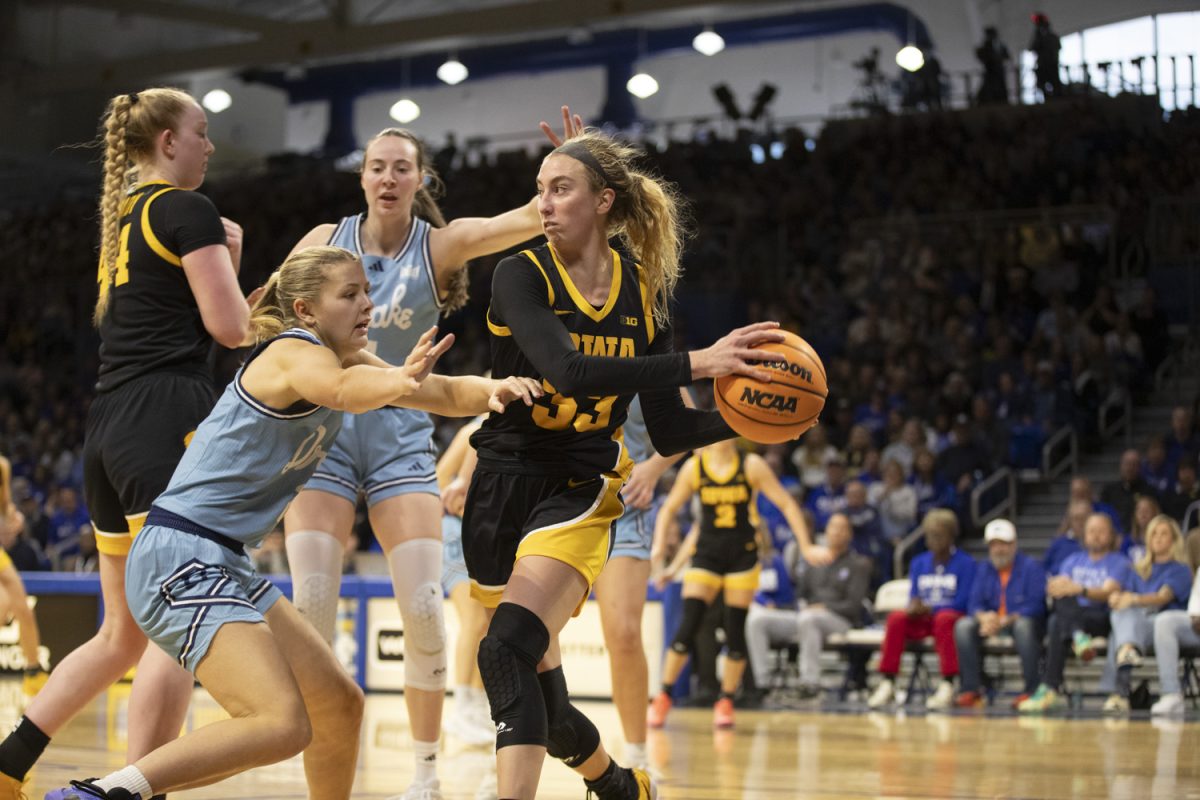 Iowa’s Lucy Olsen looks to pass during an Iowa women’s basketball game against Drake at the Knapp Center on Nov. 17 in Des Moines. The Hawkeyes defeated the Bulldogs, 86-73, with standout performances on both teams.