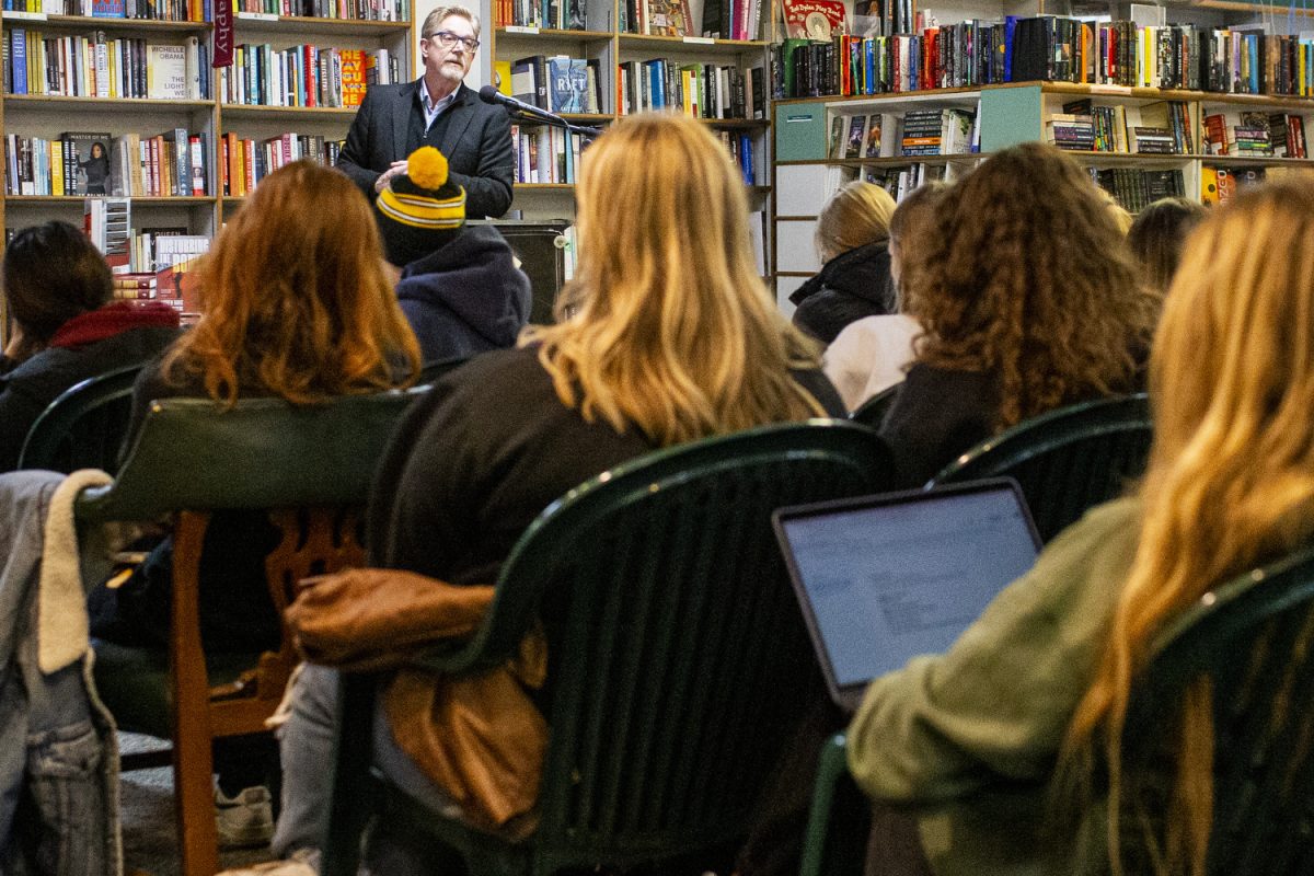 Historian, journalist, novelist, and playwright Jeff Biggers speaks during a live reading at Prairie Lights in Iowa City on Wednesday, Nov. 20, 2024. Biggers begged the question, do we still live in a failsafe world despite the nuclear capabilities that are readily accessible and likely unstoppable? In a collaborative effort between Biggers and filmmaker Andrew Davis, while combining their interest in archeology, they wrote “Disturbing the Bones,” which originally began as a screenplay. “I want to write stories about the difficult questions of our time,” said Biggers.