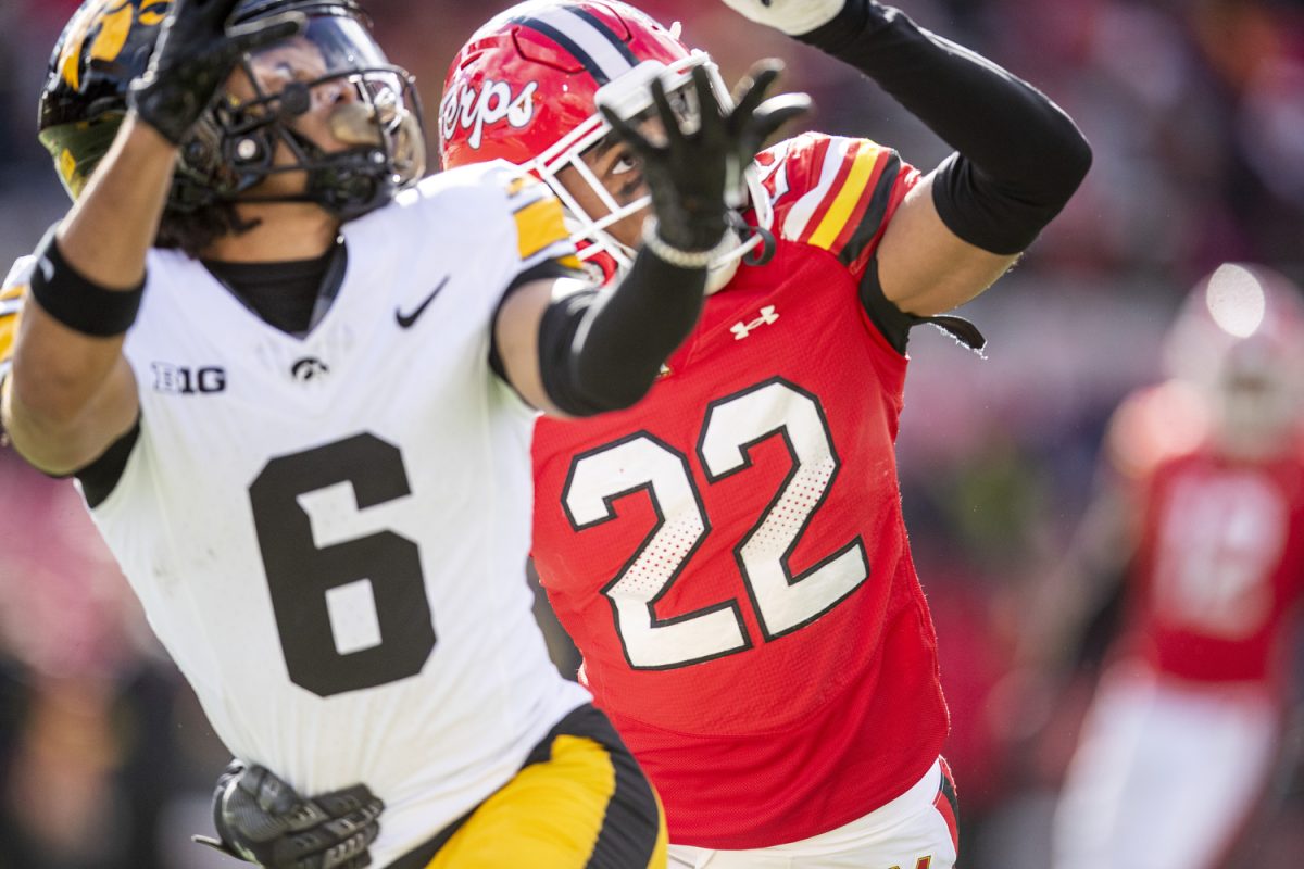 Iowa wide receiver Seth Anderson and Maryland defensive back Jalen Huskey try to catch the ball during a football game between Iowa and Maryland at SECU Stadium in College Park, Md. on Saturday, Nov. 23, 2024.