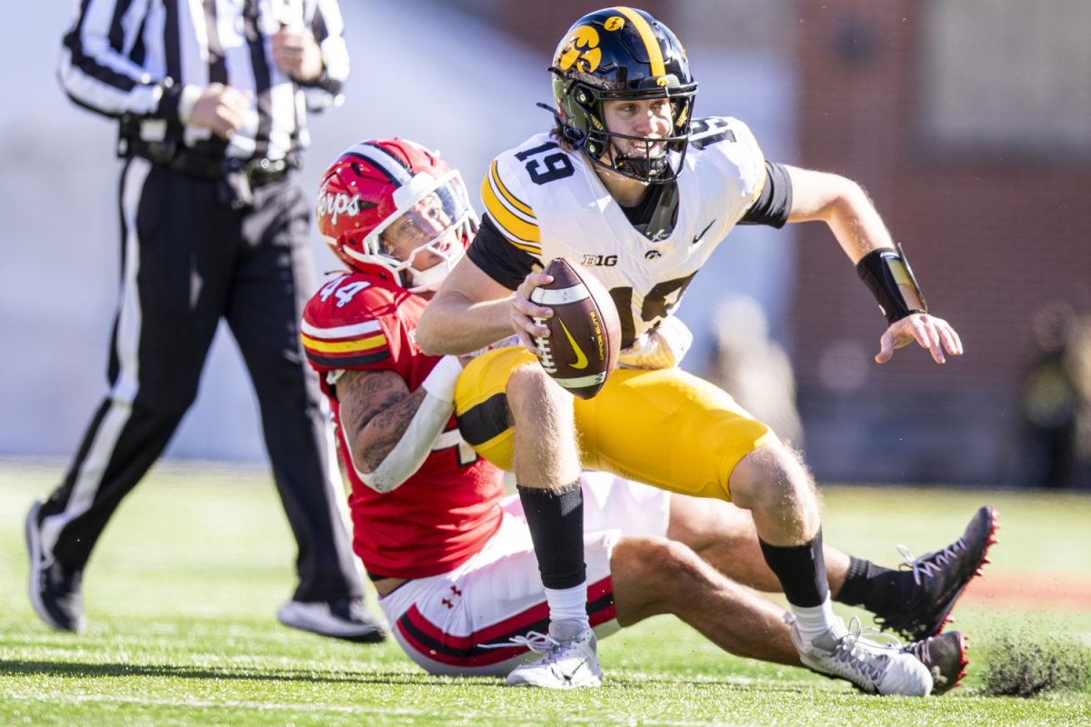 Iowa quarter back Jackson Stratton is sacked by Maryland linebacker Caleb Wheatland during a football game between Iowa and Maryland at SECU Stadium in College Park, Md. on Saturday, Nov. 23, 2024.