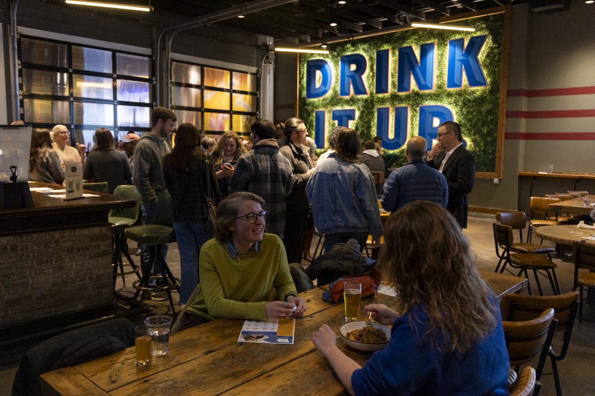 Attendees of the Iowa Legal Aid fundraiser mingle at Big Grove Brewery in Iowa City on Thursday, Nov. 21, 2024. The fundraiser featured Big Grove’s new sour beer named Fruitfully Just. 