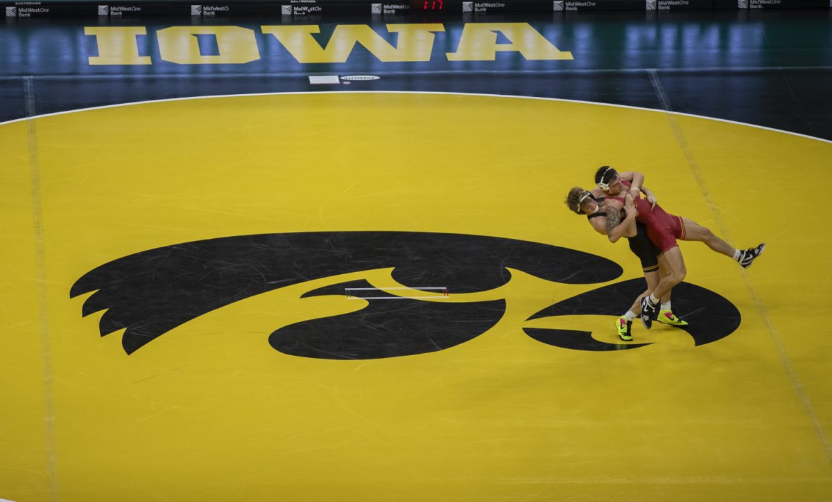 Iowa’s No. 31 141-pound Ryder Block throws Iowa State’s Zach Redding during a Cy-Hawk men’s wrestling dual between No. 2 Iowa and No. 12 Iowa State at Carver-Hawkeye Arena in Iowa City on Saturday, Nov. 23, 2024. The Hawkeyes defeated the Cyclones 21-15.